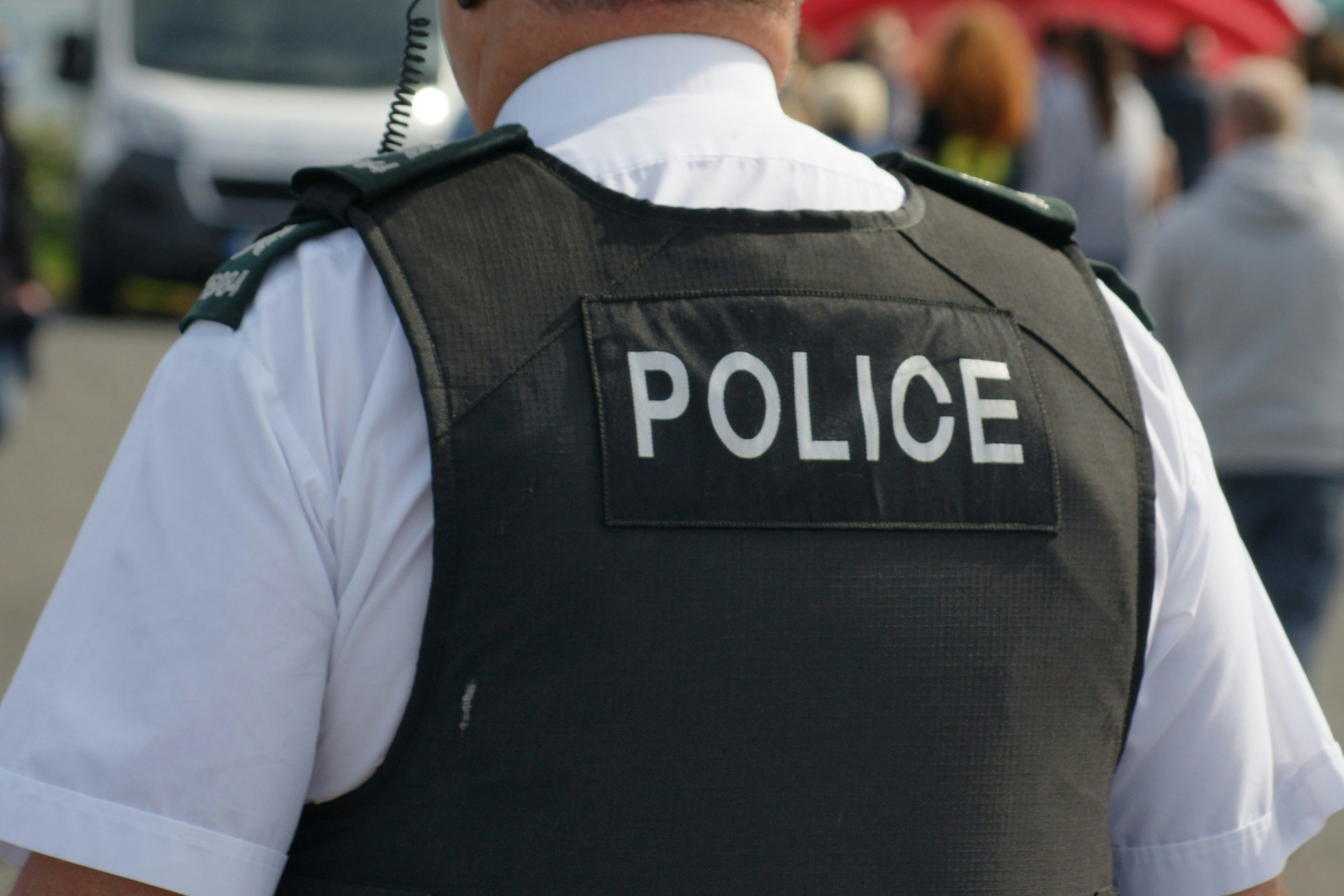 Photo of close-up of police office in police vest.
